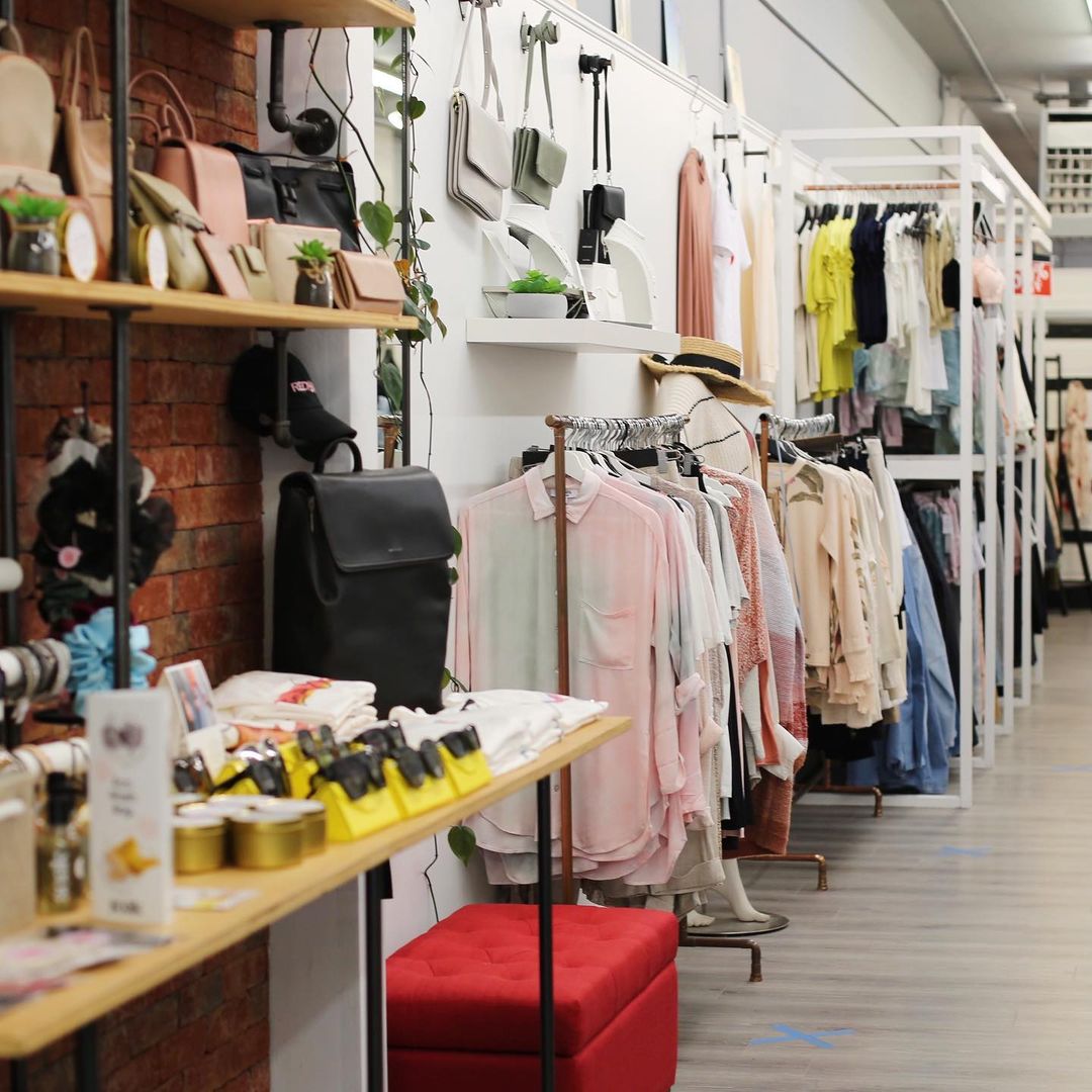 Walls of clothing and merchandise in a women's fashion boutique.