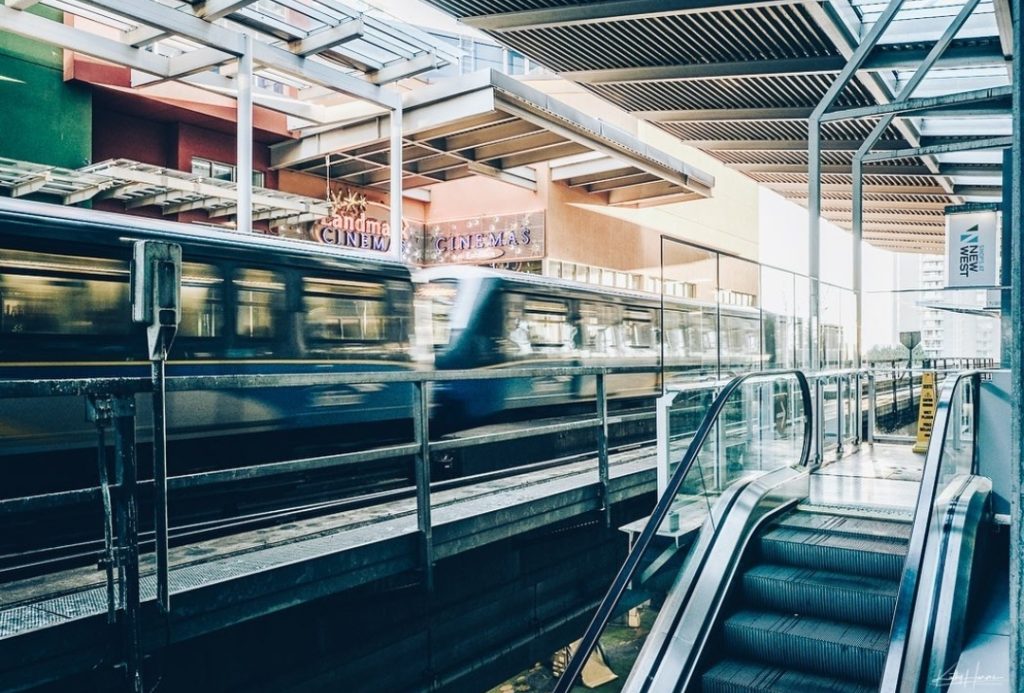 New Westminster skytrain station escalators and skytrain outside of Landmark Cinemas